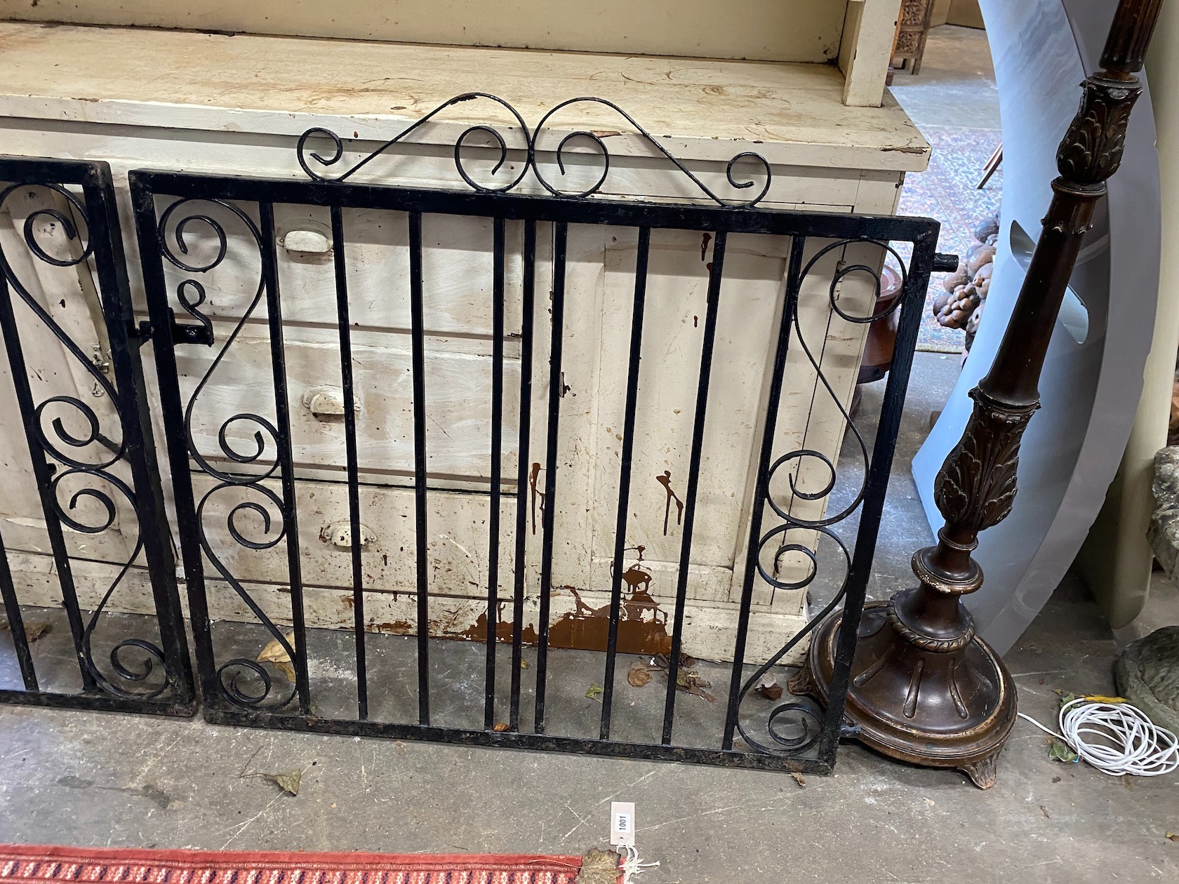 A pair of painted wrought iron garden gates, each gate width 101cm, height 99cm together with a Victorian cast iron campana urn section